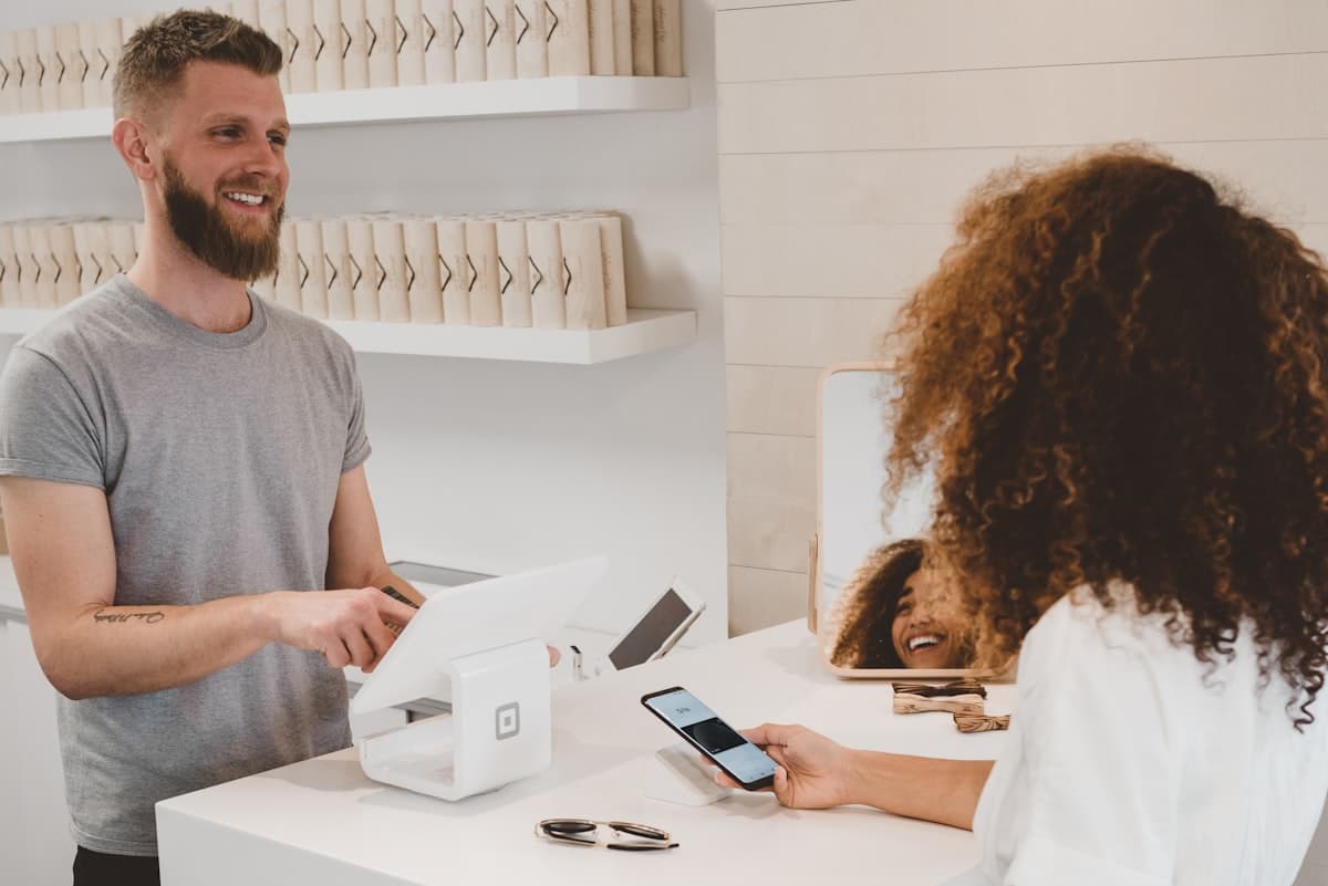 Person using a laptop computer while holding a credit card for online shopping