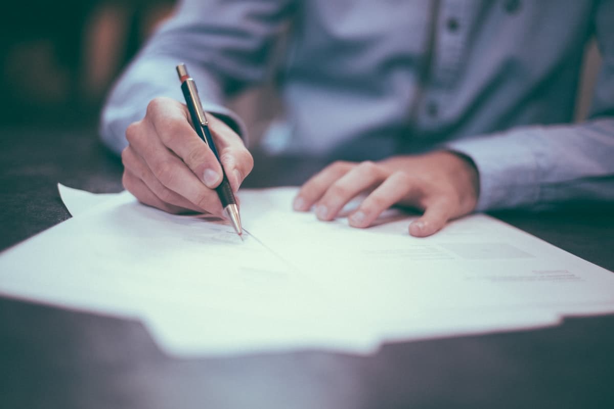 Person reviewing financial documents and receipts at a desk with a calculator