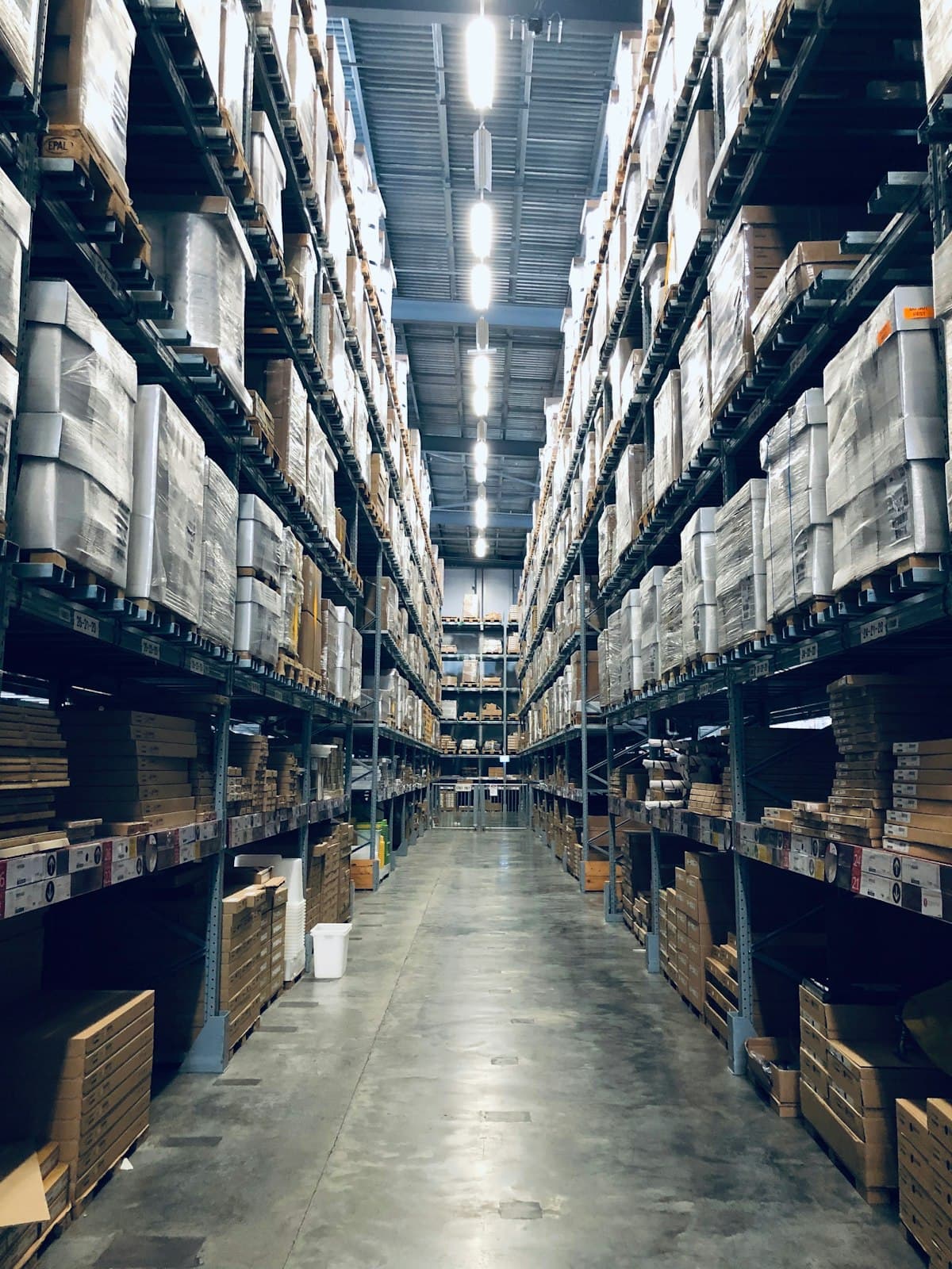 Interior of a large warehouse with tall shelving racks and organized inventory storage