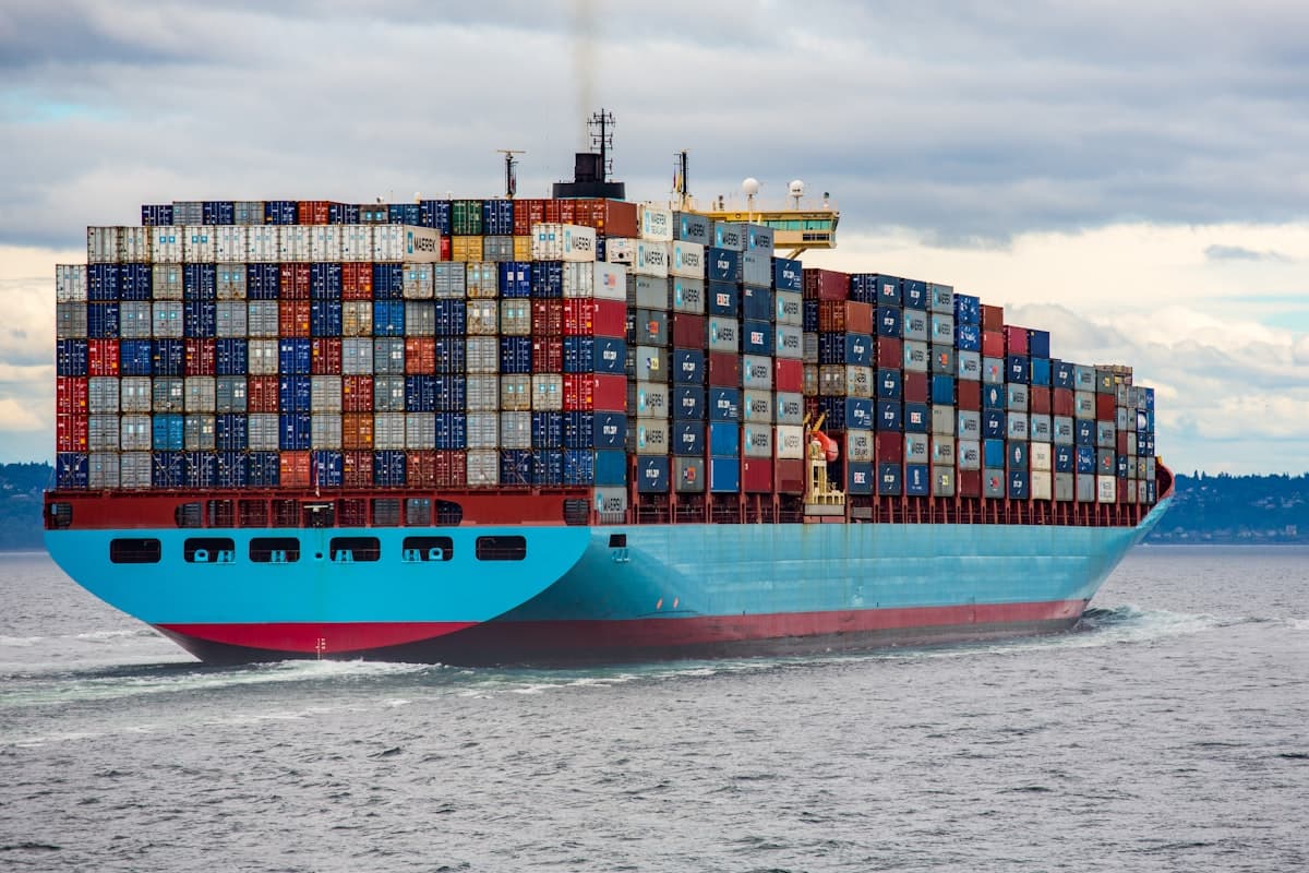 Maersk container ship loaded with colorful shipping containers at sea